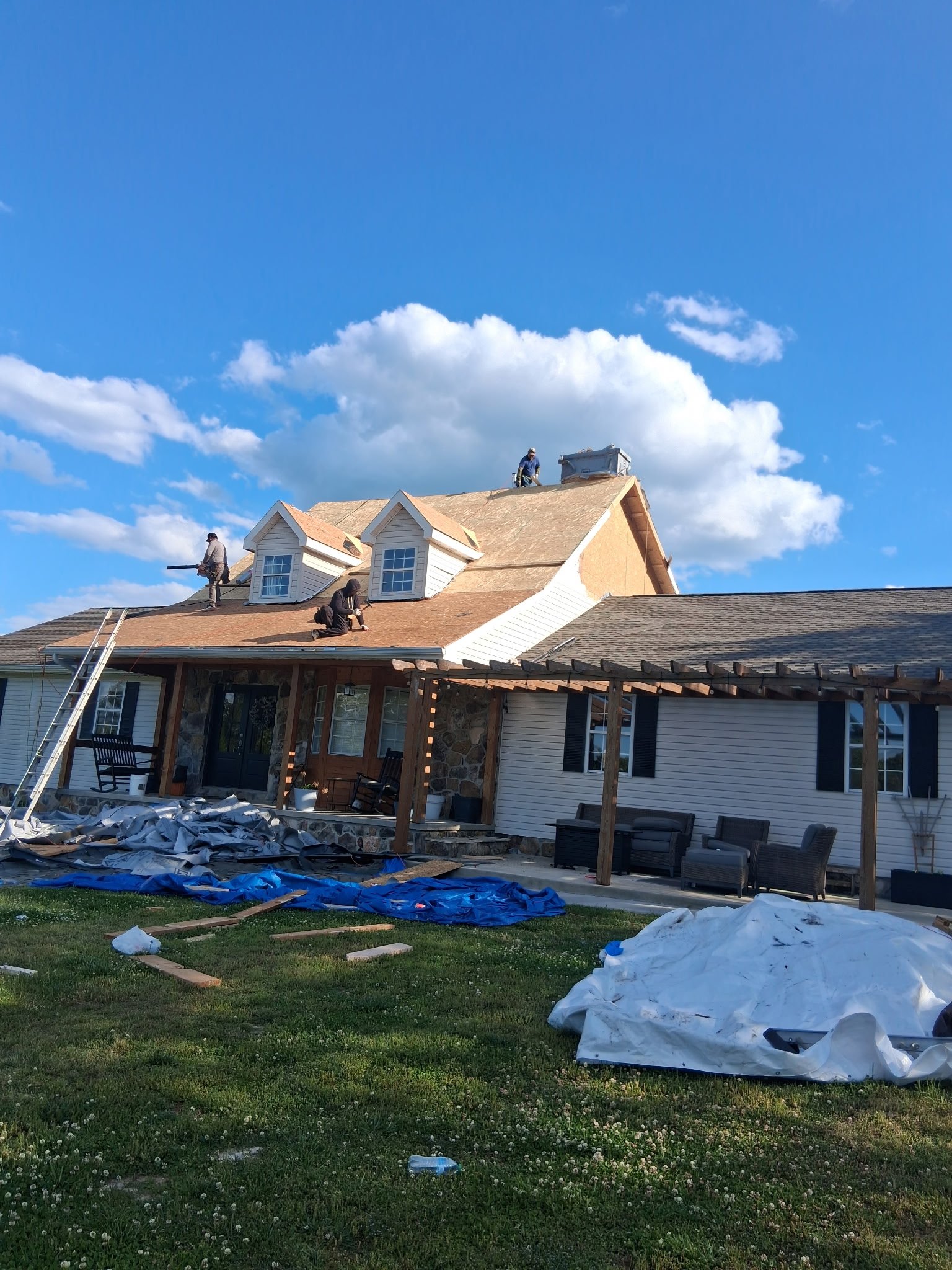 Roofing crew replacing shingles on residential home in Chattanooga TN